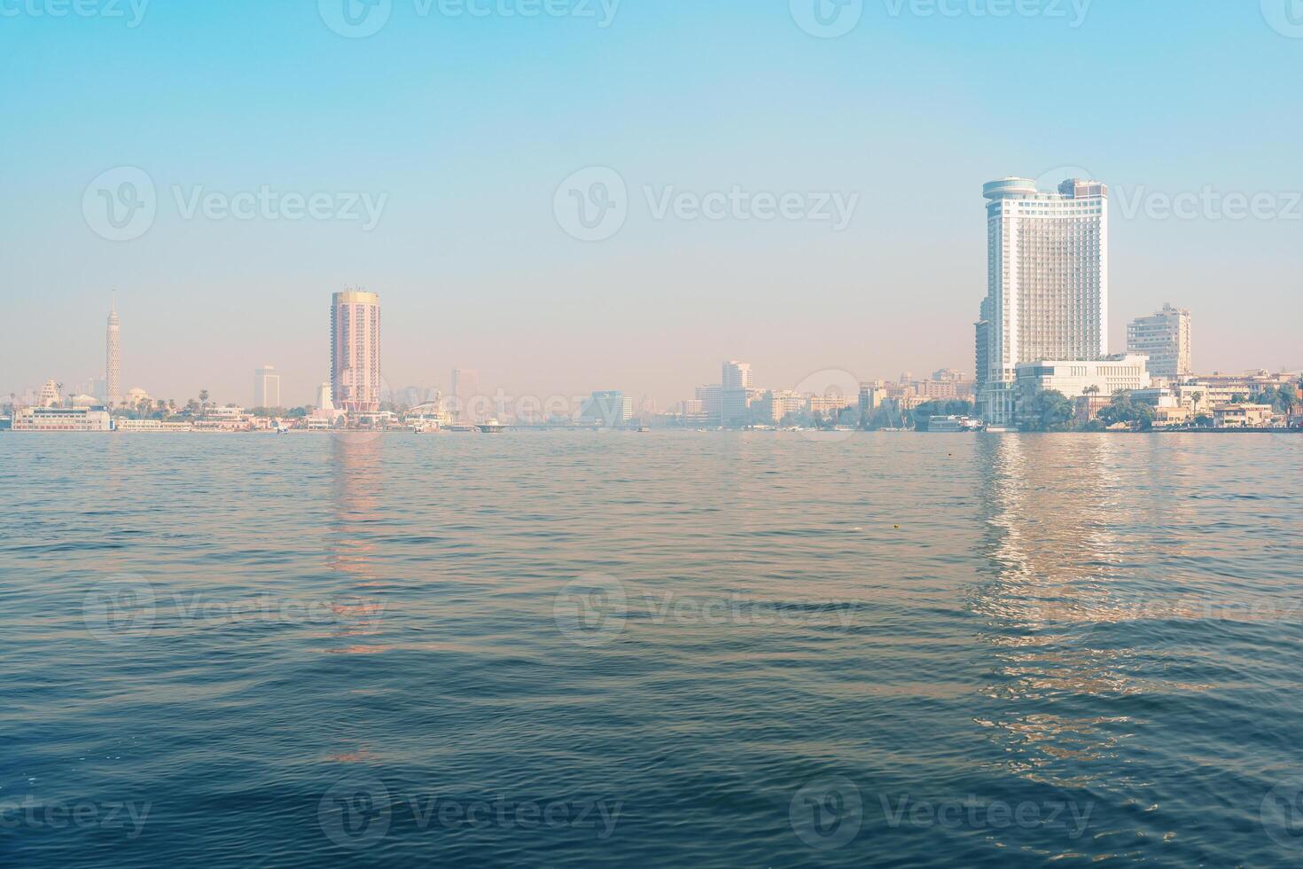 Majestic view of Cairo skyline over the Nile River on a clear morning showcasing urban architecture and tranquil waters photo
