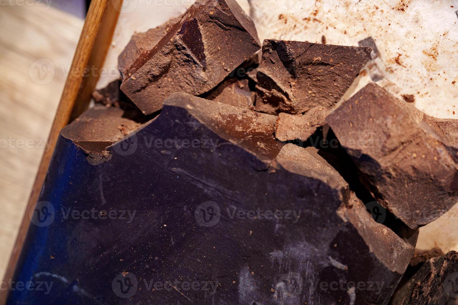 Dark chocolate chunks ready for melting and baking in a kitchen setting during the day photo