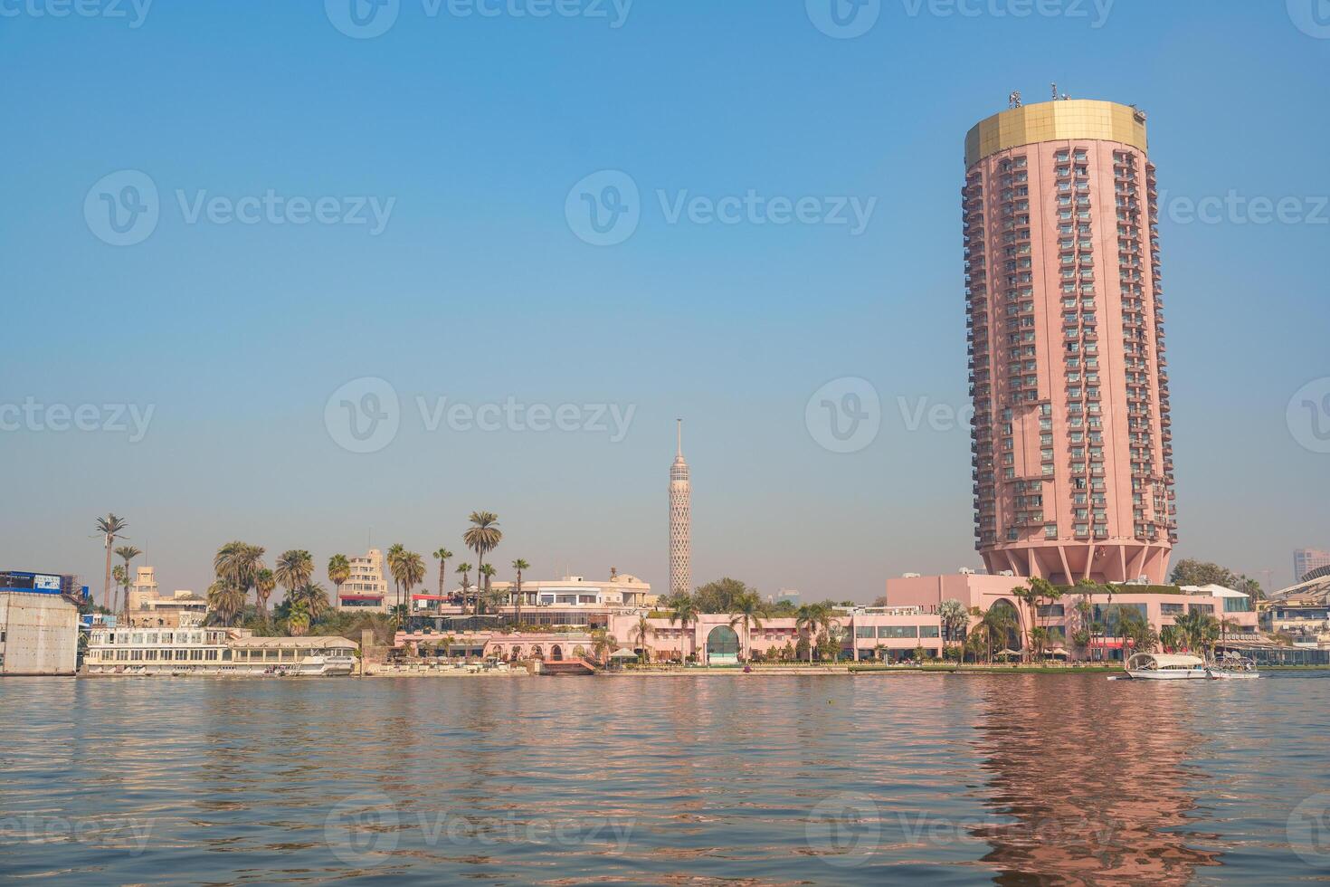 Skyline view of Cairo featuring the Nile River and modern architecture at sunset photo