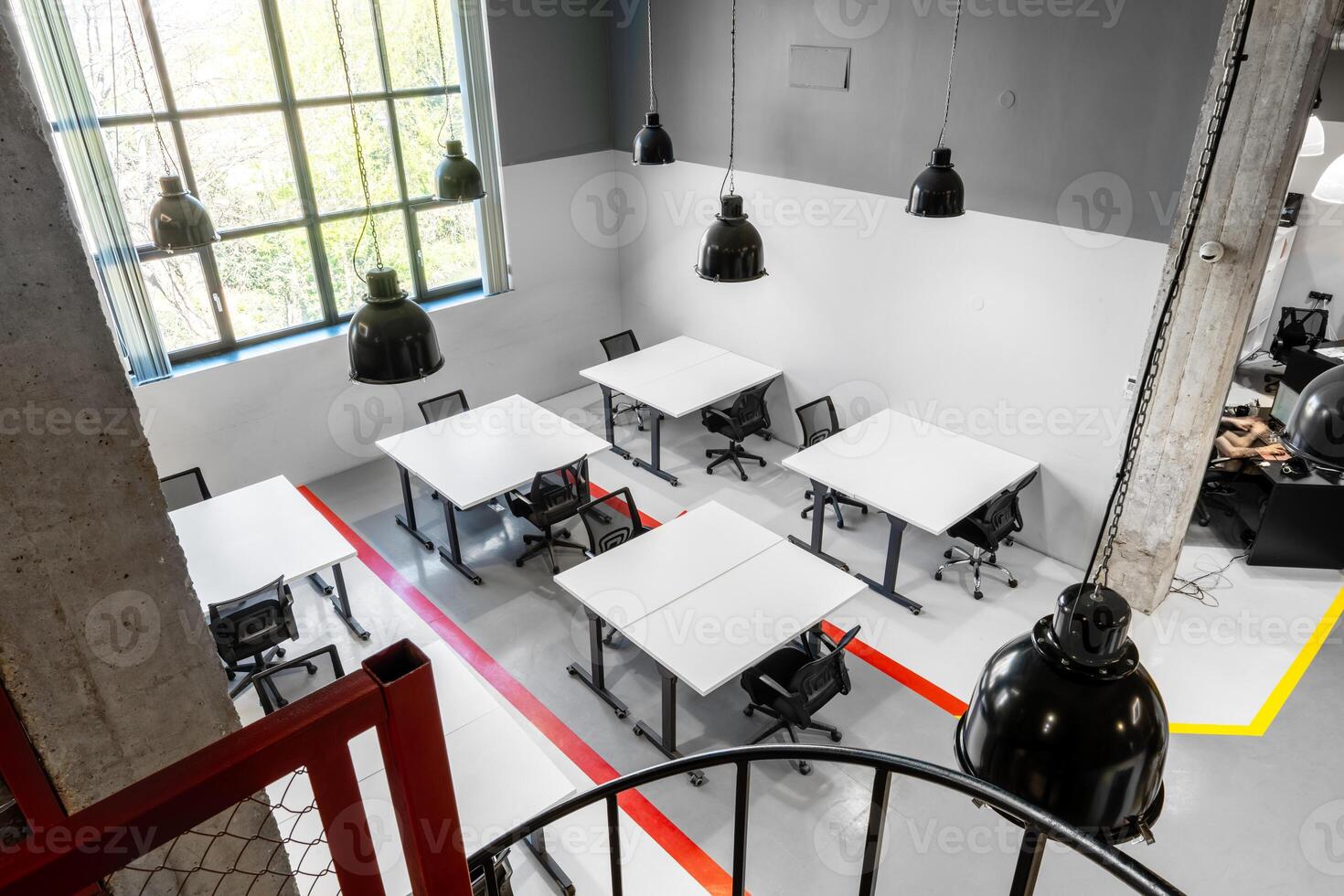 Modern coworking space with large windows and minimalist design in a busy urban setting photo