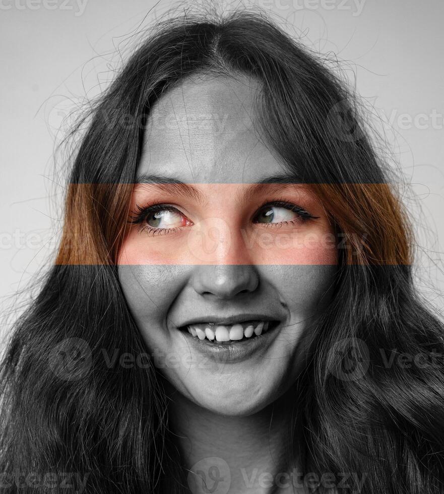 Engaging portrait of a young woman with expressive eyes and a playful smile in a creative art setting photo
