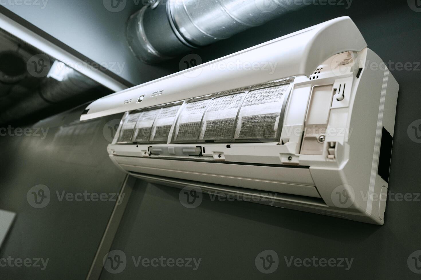 Efficient wall-mounted air conditioning unit installed in a modern indoor space for optimal cooling comfort photo