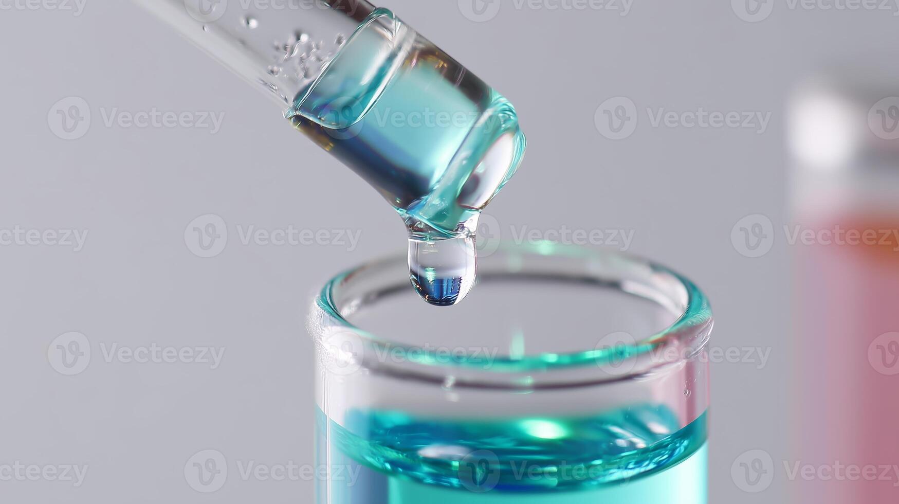 Close-up of a pipette releasing a blue liquid into a glass test tube in a laboratory setting photo