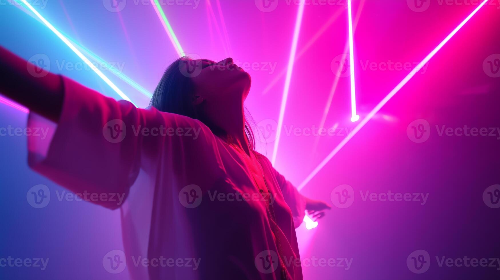 Bright colored lights create a vibrant atmosphere as a person enjoys the party at a nightlife venue photo