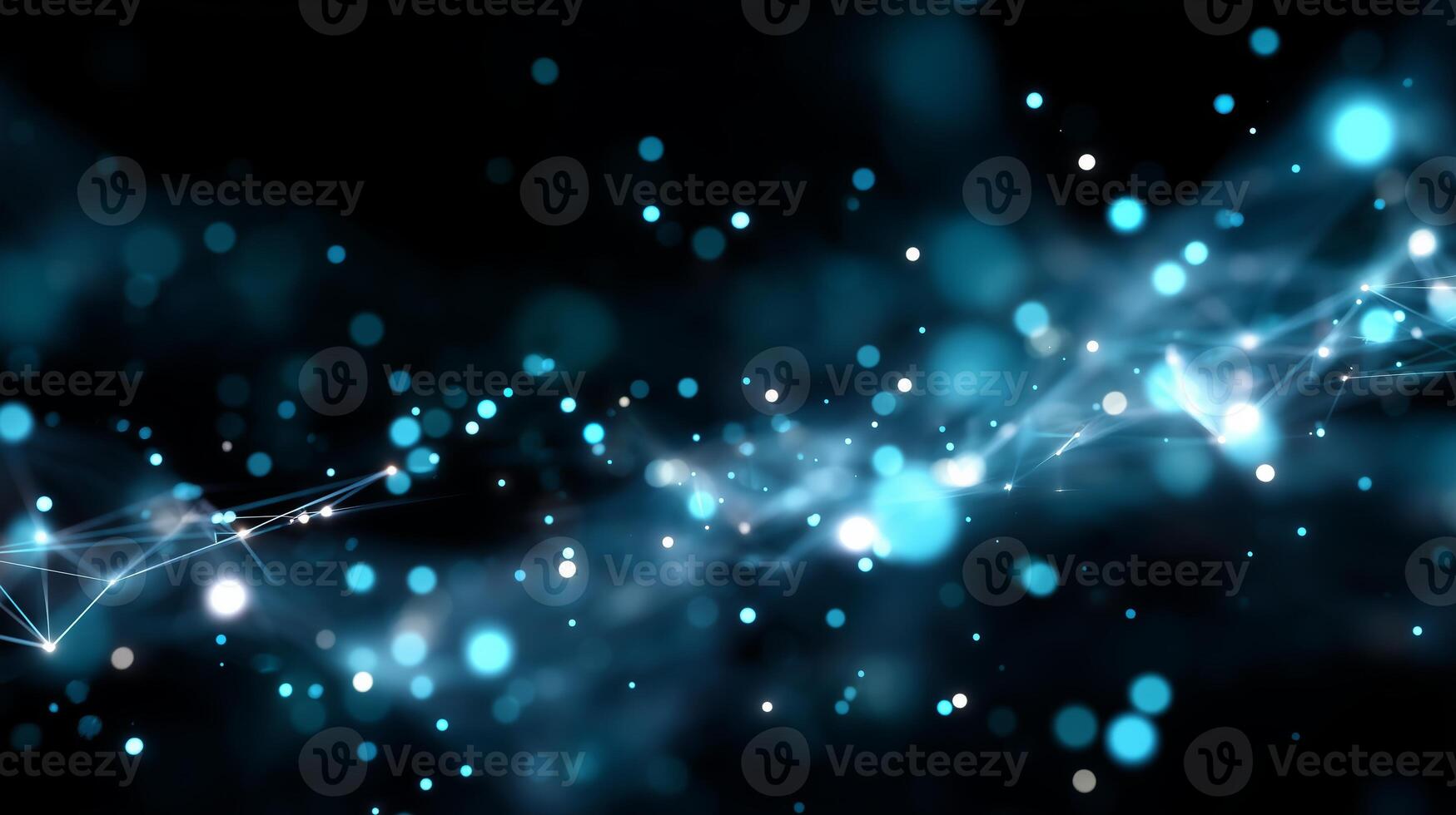 Bright blue particles float in a dark space creating an abstract cosmic background photo