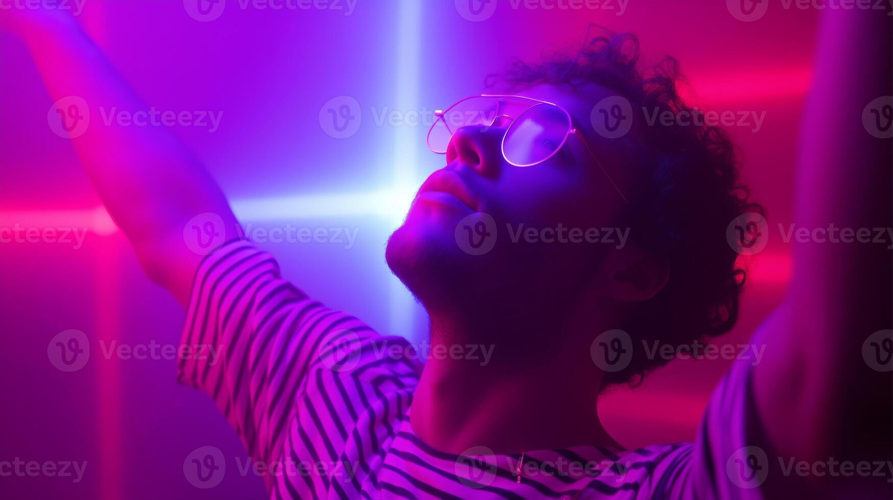 Colorful light display energizes a person during an indoor dance party at night photo