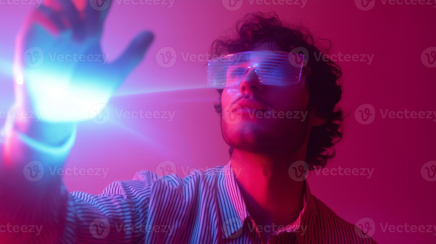 Young person using futuristic glasses in a colorful light display photo