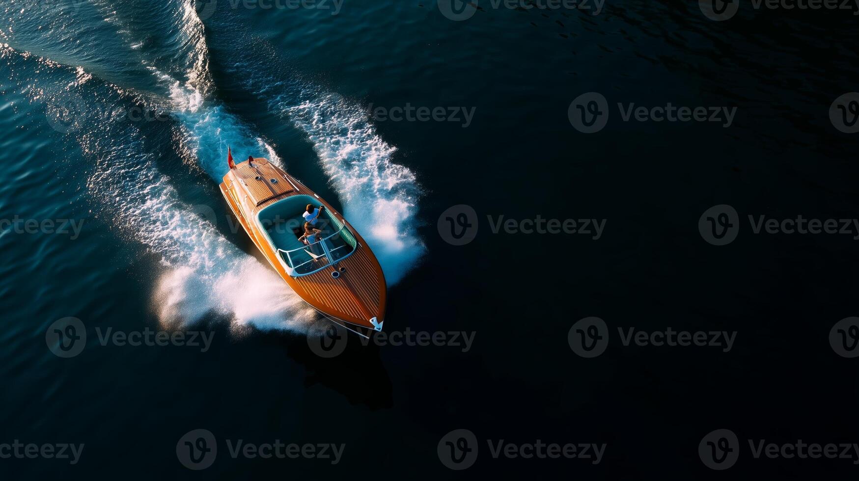 Speeding through clear waters on a sunny day in a sleek wooden speedboat photo