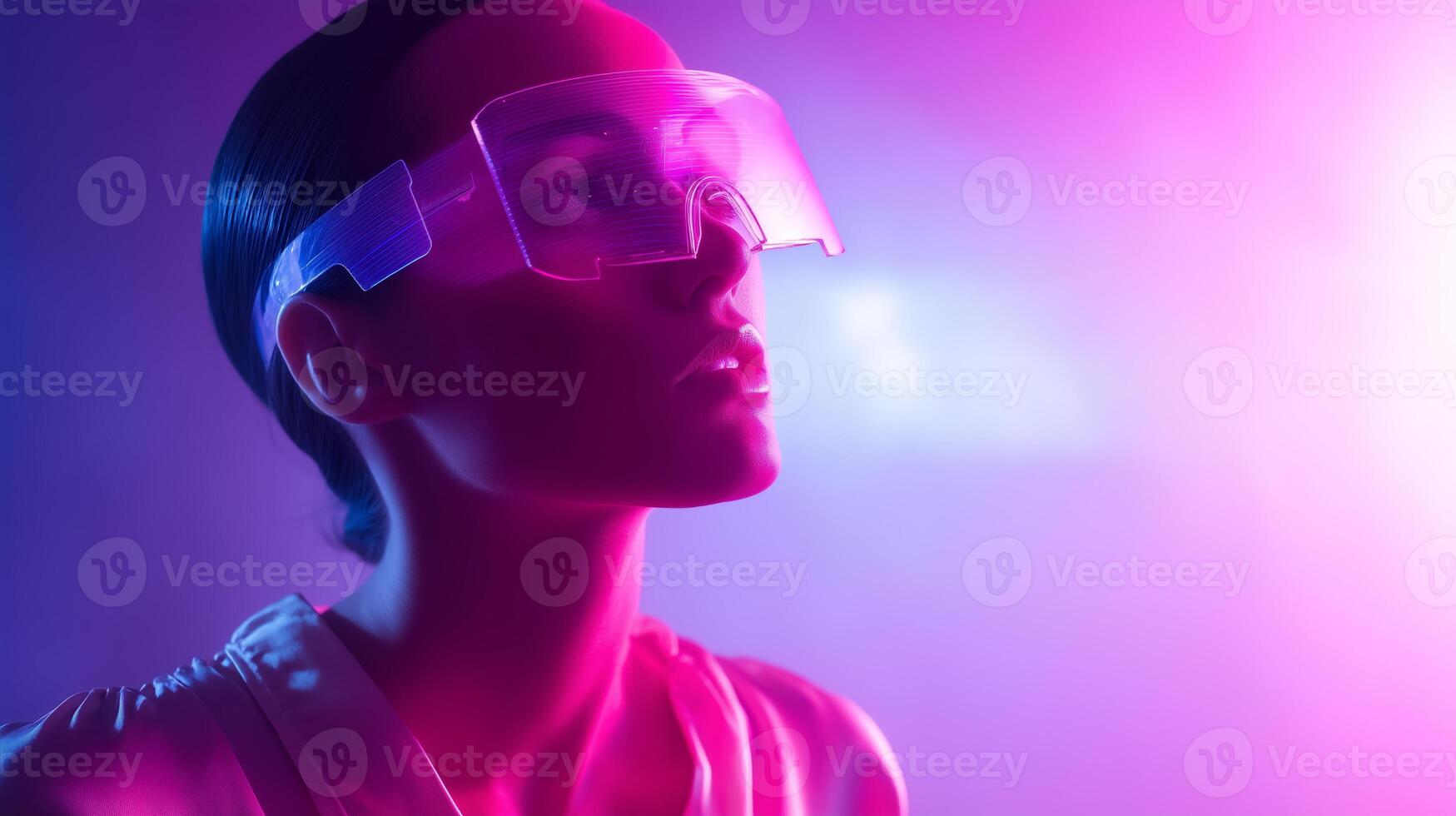 Model poses in futuristic glasses illuminated by vibrant purple and pink lights during a creative photoshoot in a studio setting photo