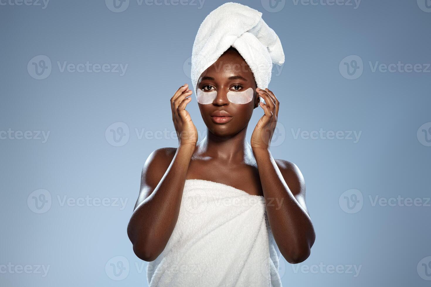 Woman applying skincare mask and preparing for self-care routine indoors in well-lit space photo