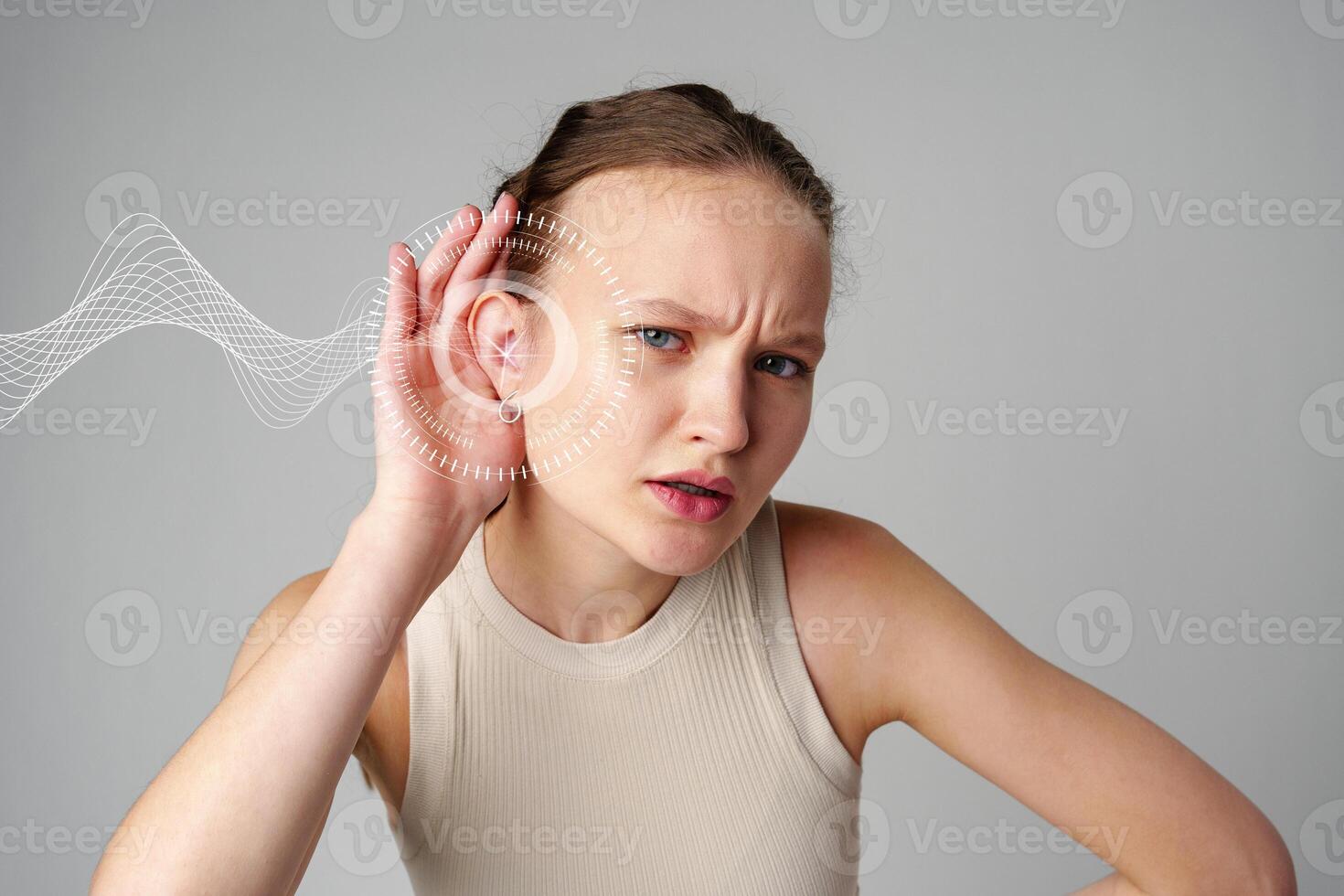 Young woman listening intently while experiencing sound waves in a minimalist studio setting photo