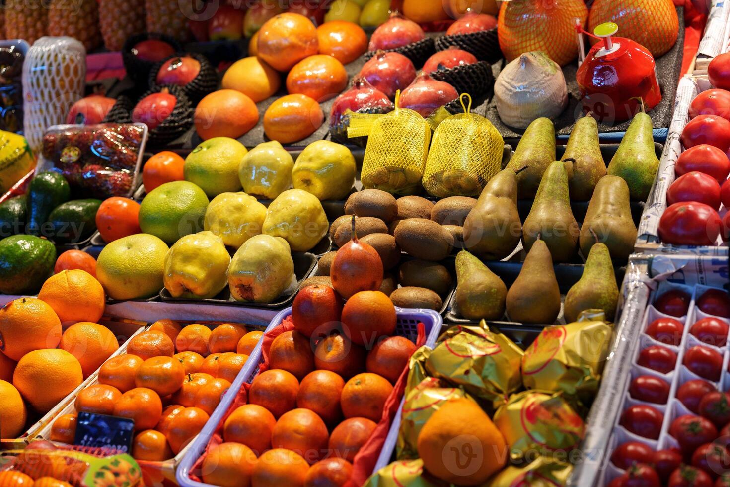 Colorful variety of fresh fruits displayed at a market in the evening light photo