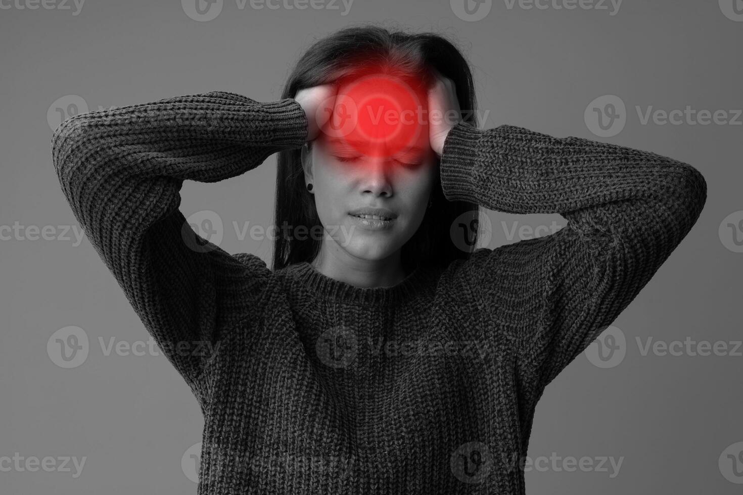 Young woman experiencing severe headache in a minimalistic indoor setting during daylight hours photo