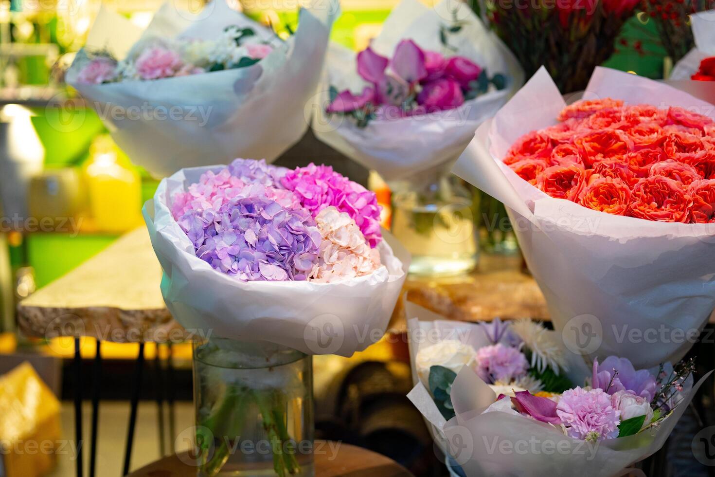 Colorful flower bouquets displayed in a vibrant shop during the daytime with bright lighting photo