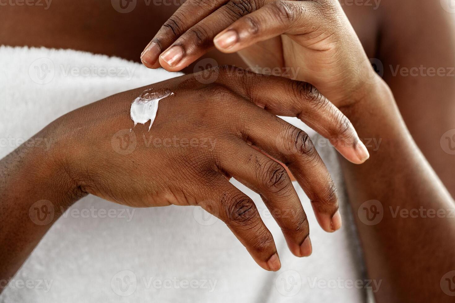 Applying moisturizer on hands after a relaxing spa treatment at home during a Sunday afternoon photo