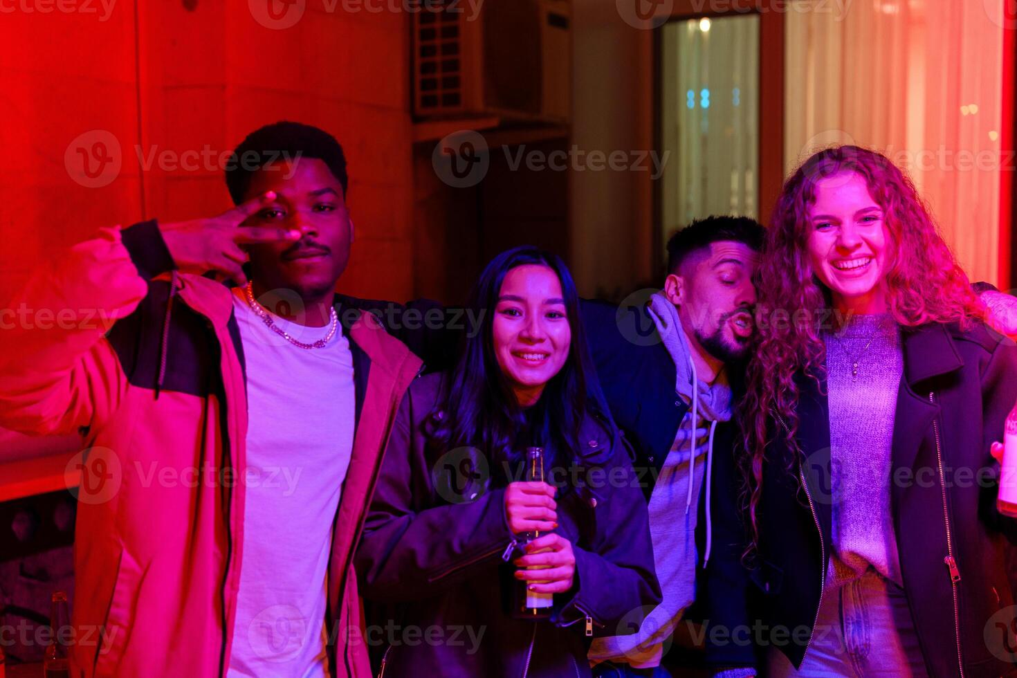 Group of friends celebrating together in a brightly lit room during a festive evening gathering in the city photo