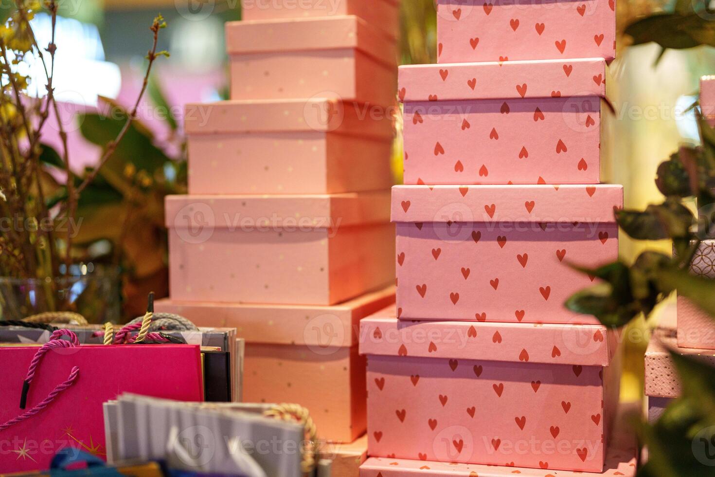 Display of decorative gift boxes arranged in a retail setting during the holiday season photo