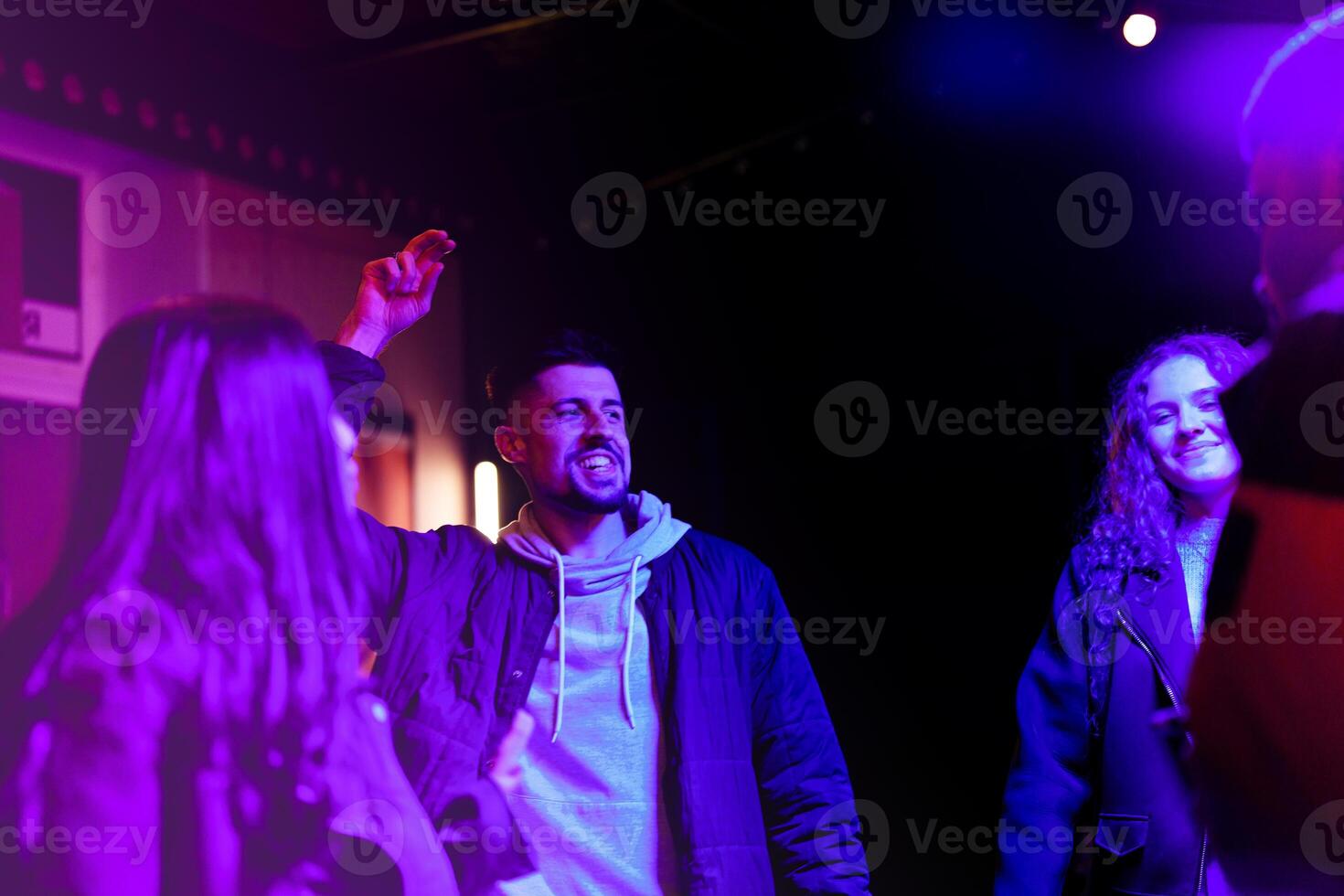 Friends enjoying vibrant nightlife in a lively venue during the evening hours photo