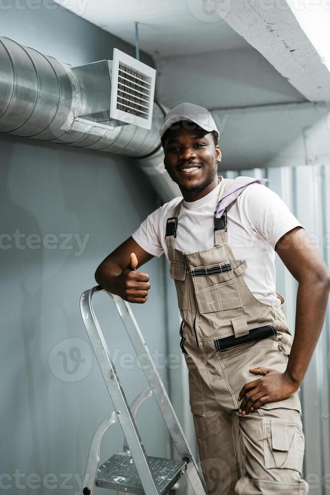 Skilled worker proudly completing installation in a modern building during daylight hours photo