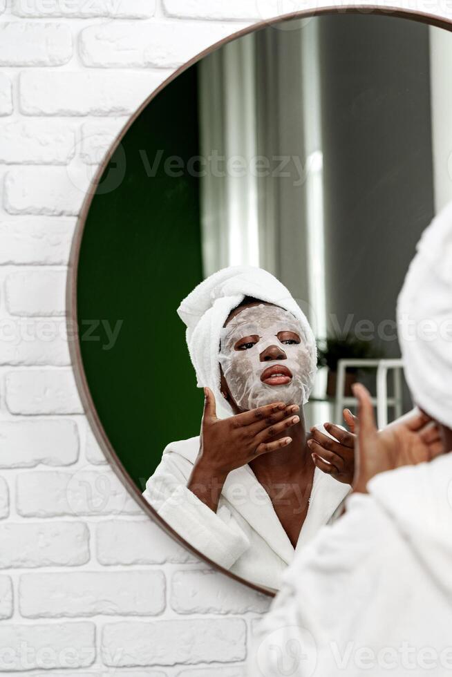Enjoying a self-care routine with a facial mask in a cozy bathroom setting photo