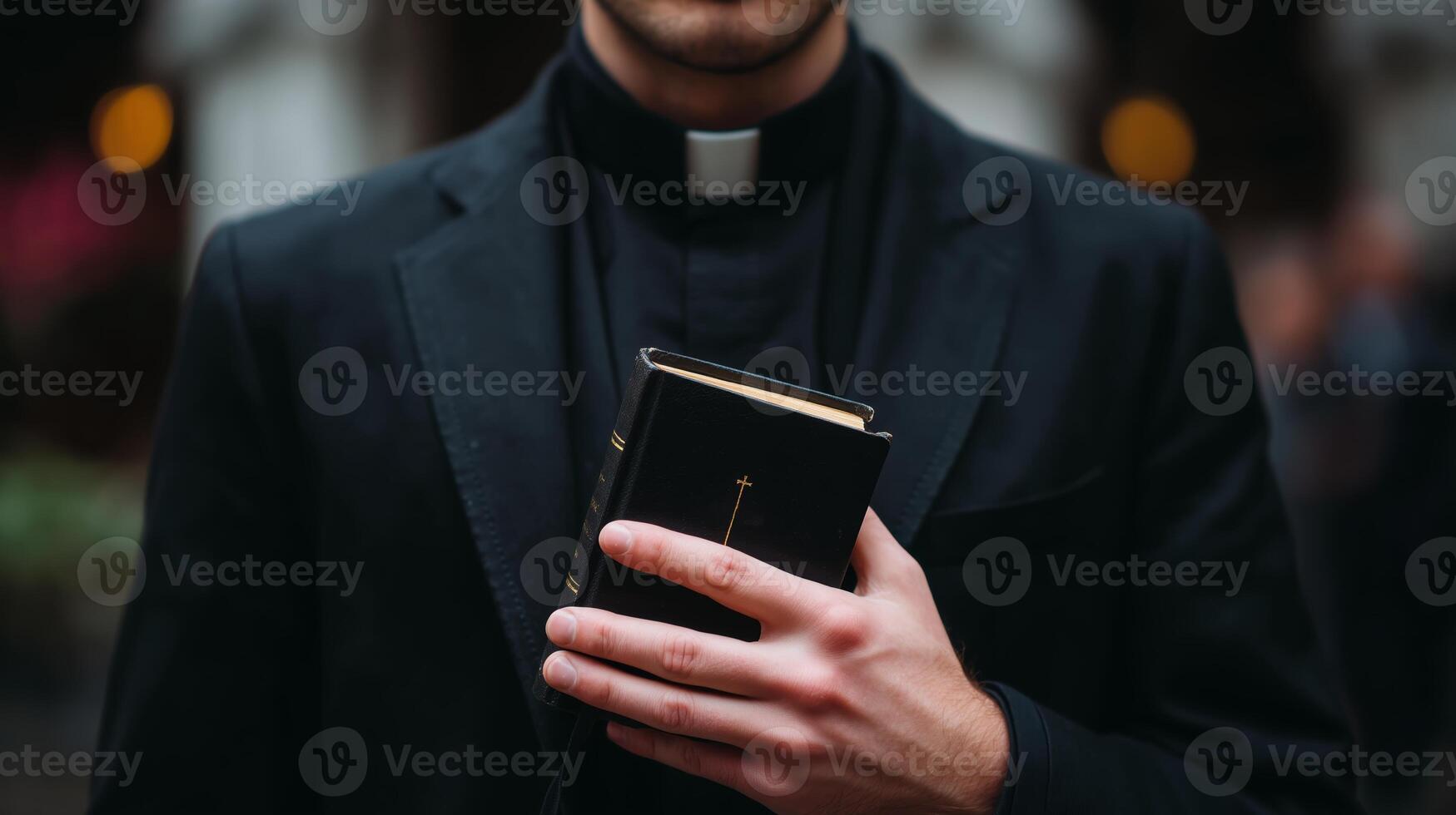 Priest holding a book in a formal setting while preparing for a religious ceremony during evening hours photo