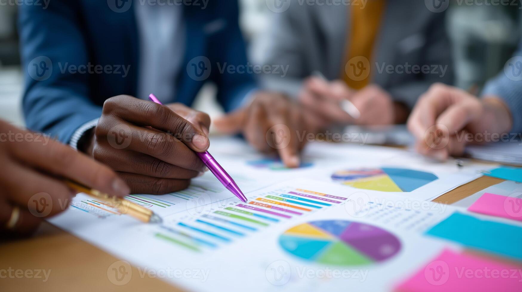 Team collaborating on data analysis using charts and graphs to drive business decisions during a meeting in an office photo