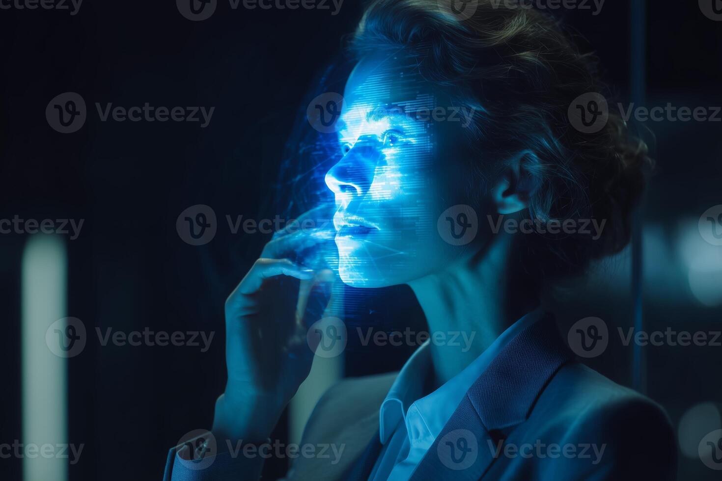 Woman interacting with a holographic interface in a dimly lit futuristic environment photo