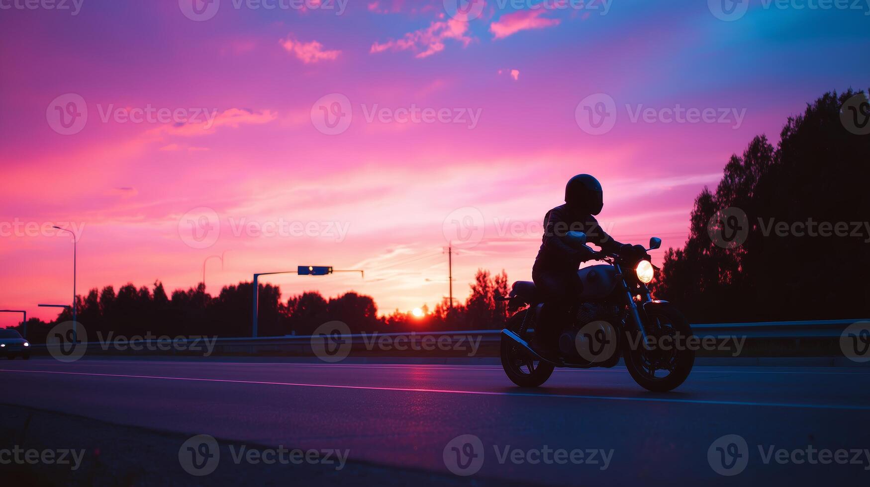 Motorcycle ride under vibrant sunset sky along quiet road during twilight photo