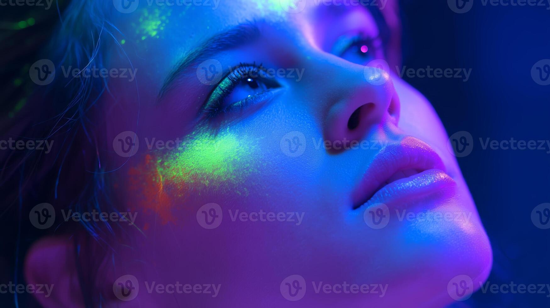 Creative portrait highlighting vibrant light effects and makeup artistry on a model's face during a photoshoot photo