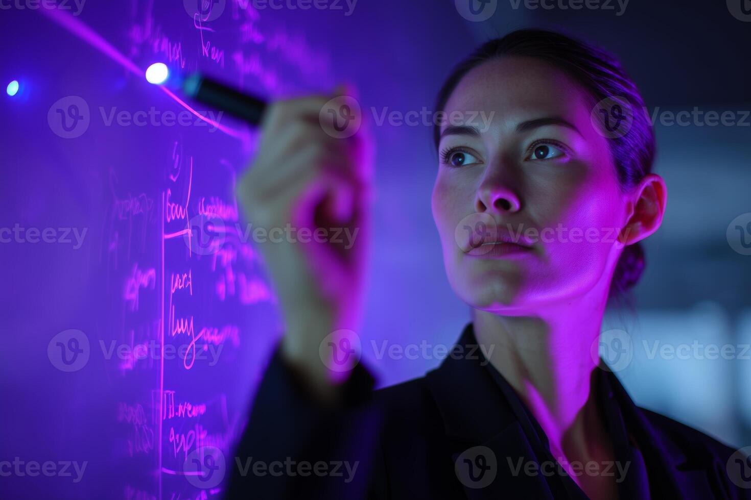 Scientist conducting research with a UV light in a modern laboratory while writing on a blackboard photo