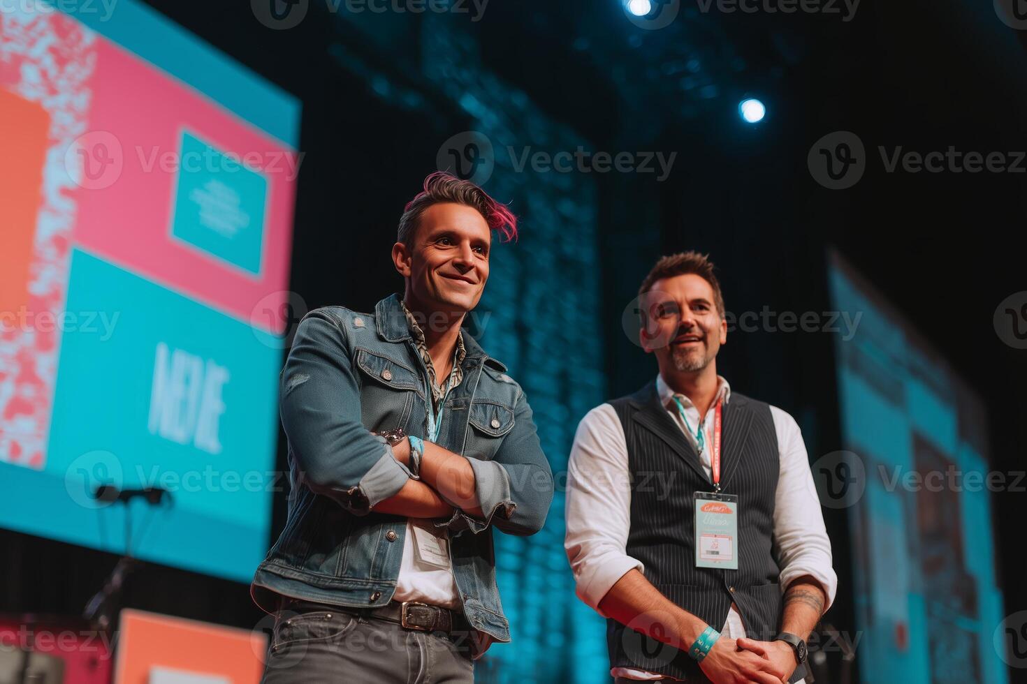 Two presenters engaging the audience at a lively event focused on innovation and creativity in a modern venue photo