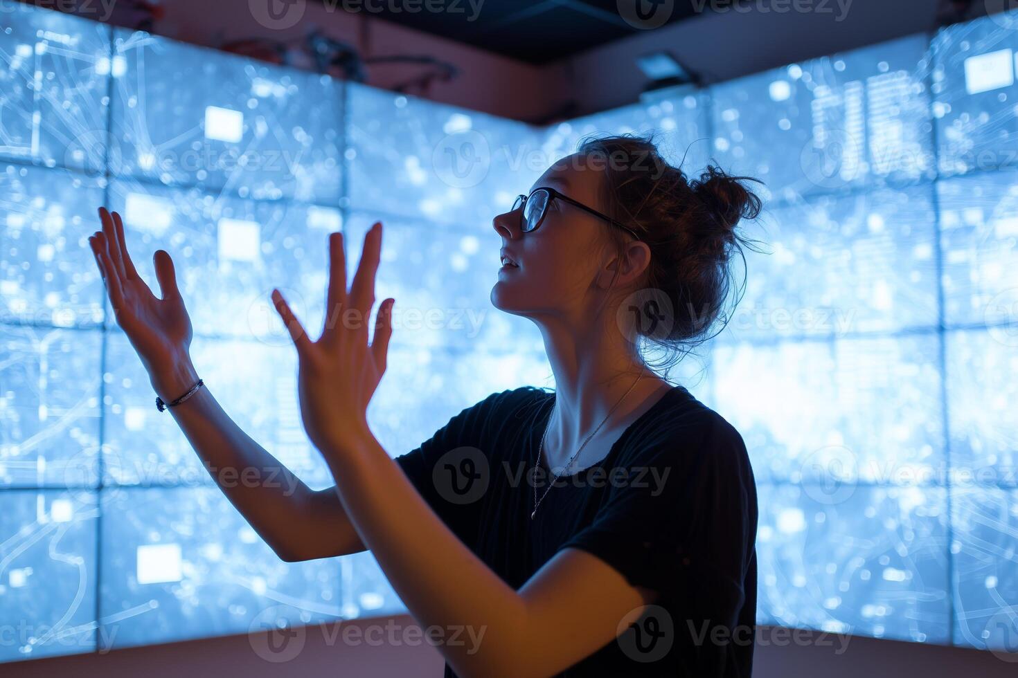 Enthusiastic woman interacts with digital display in technology exhibition space photo