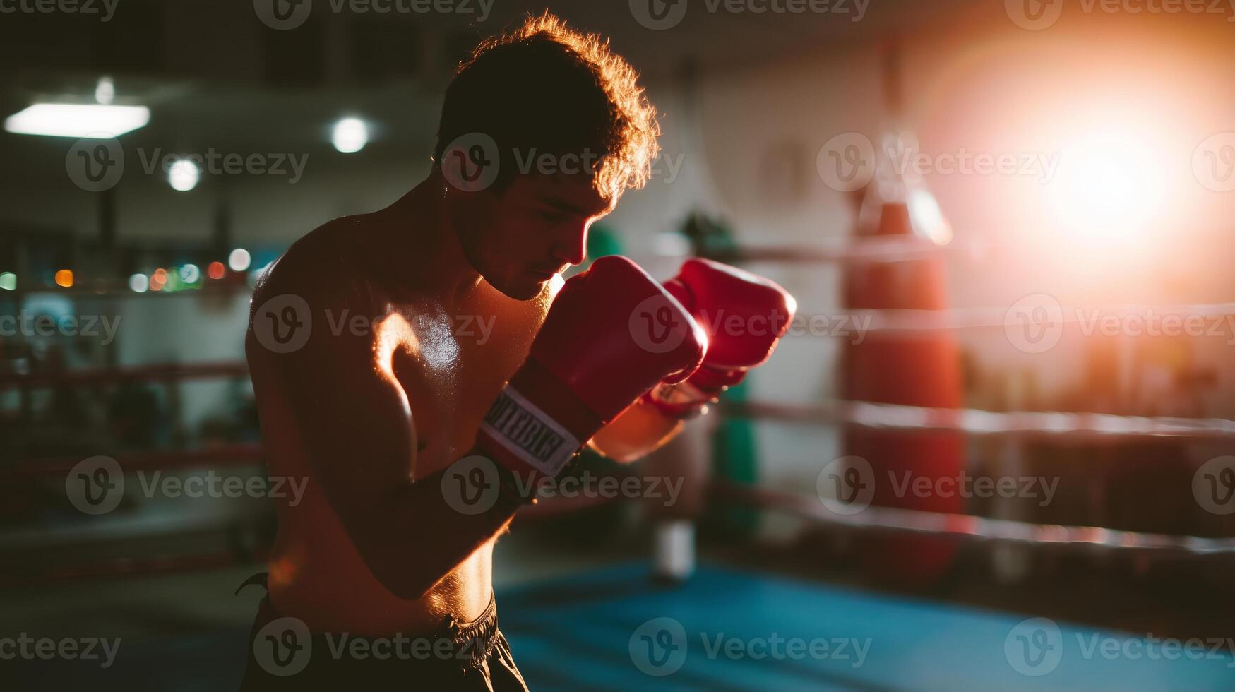 Boxer training intensely in gym with focus on technique and strength during evening workout session photo