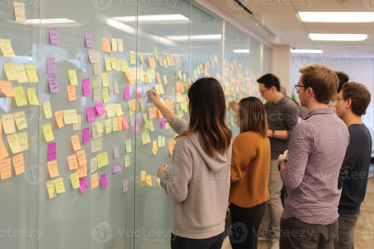 Team collaborates on brainstorming session with sticky notes in modern office environment photo