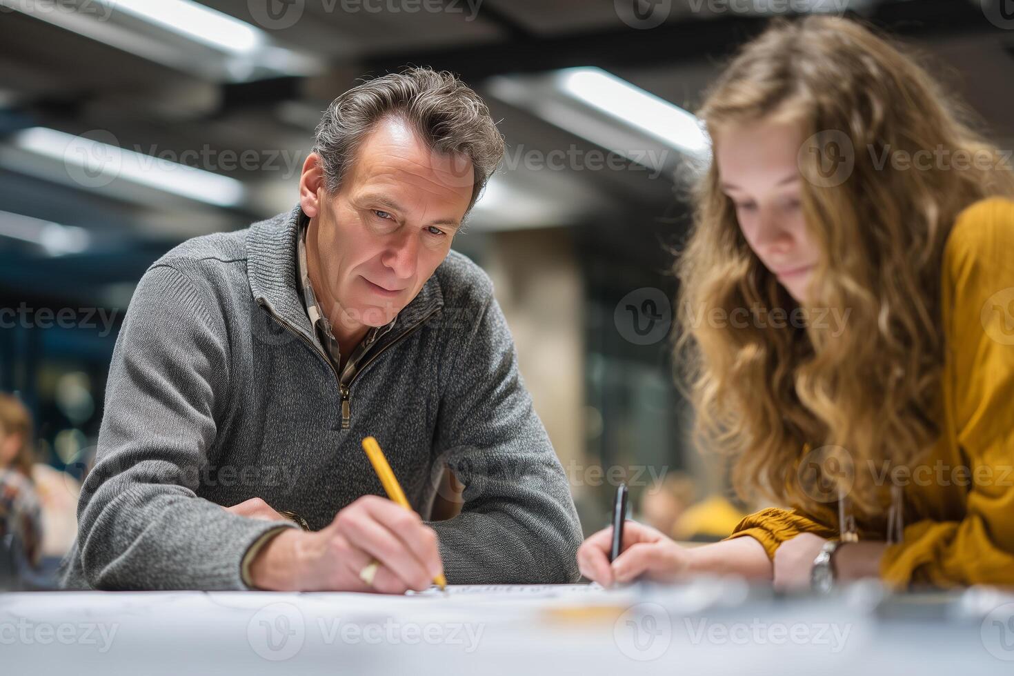 Collaborative project work between a man and a woman in a modern workspace during the evening photo