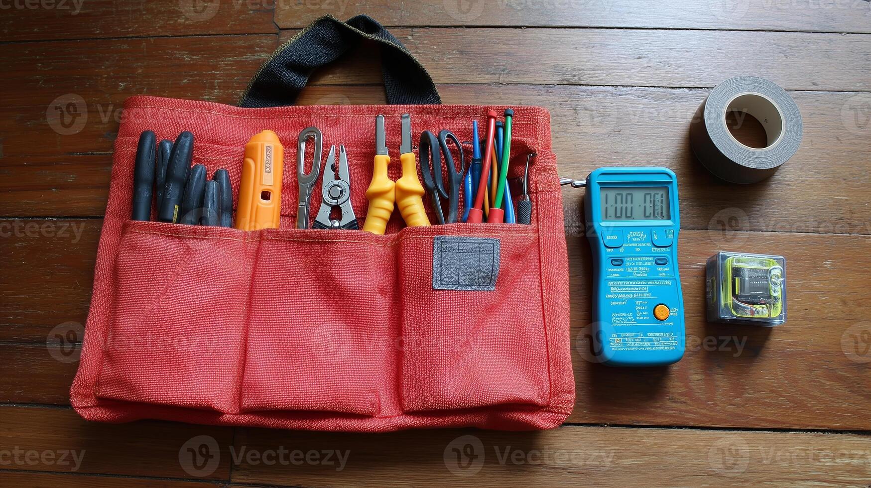 Utility tool pouch with various hand tools and measuring devices on wooden floor photo