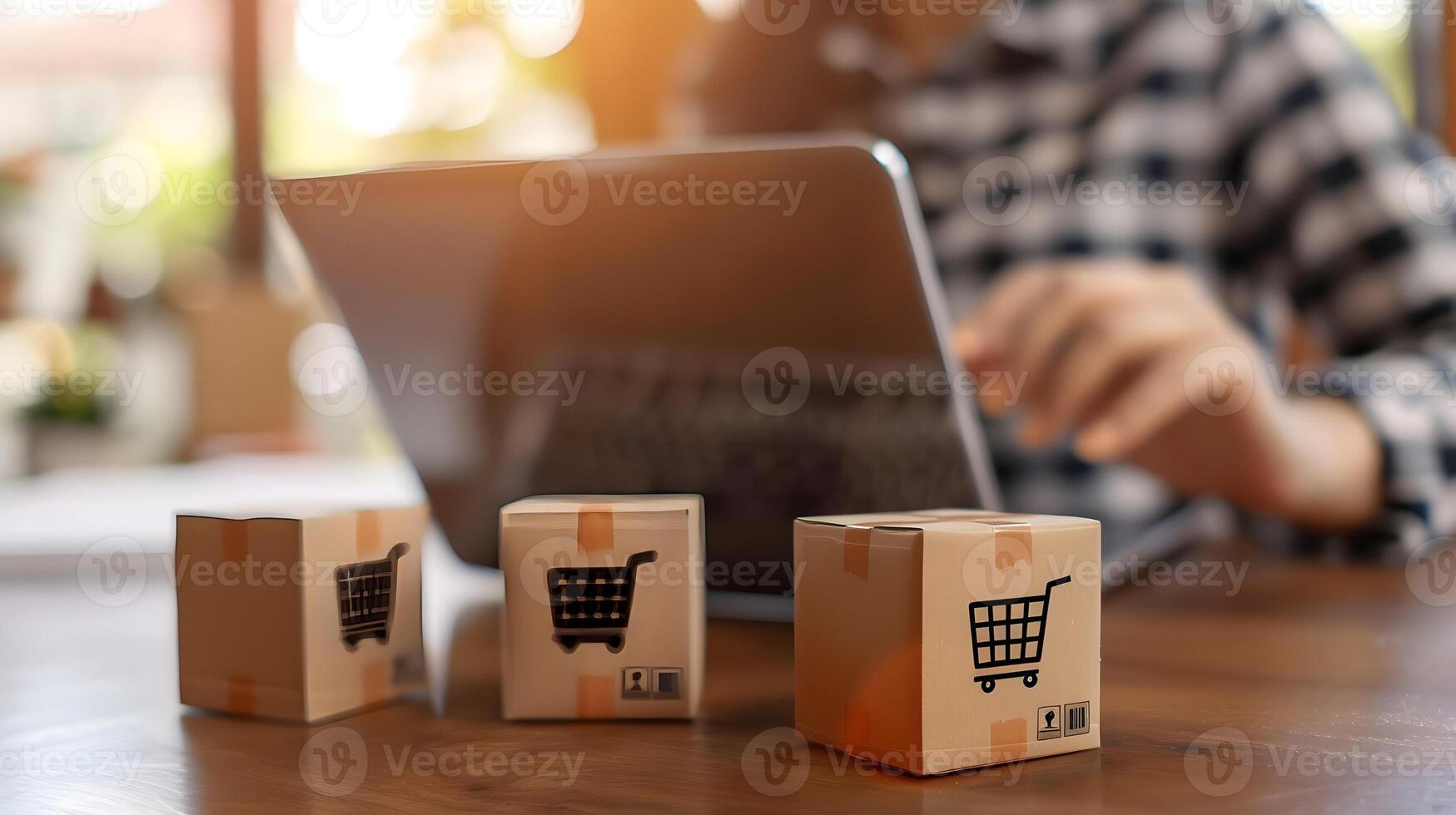 Shopping cart on laptop with boxes on table photo
