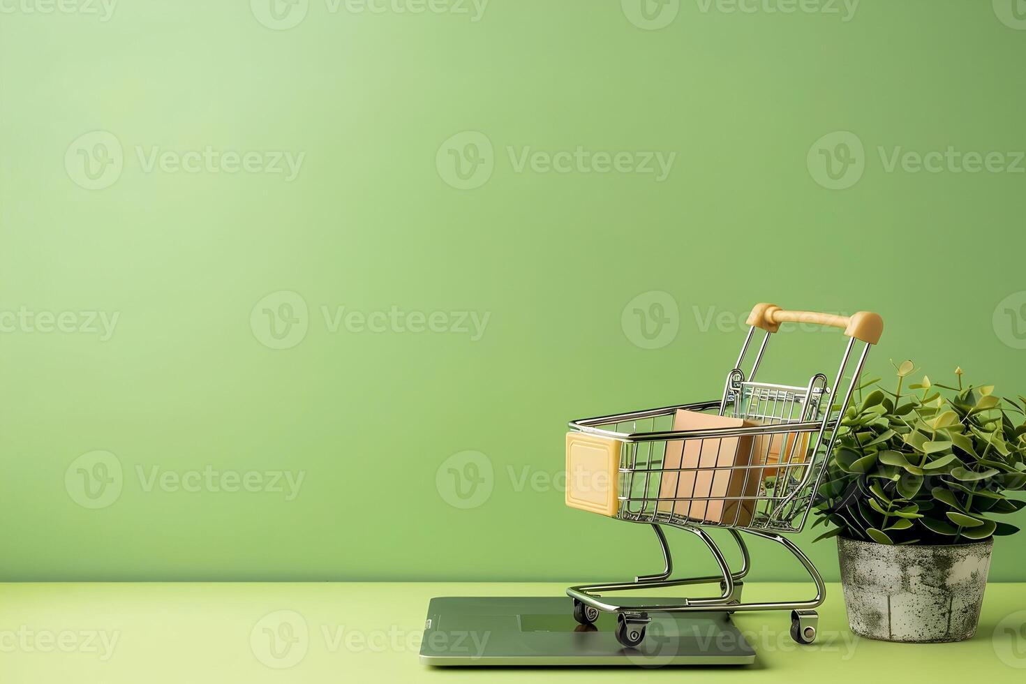 Shopping cart on laptop and green background photo