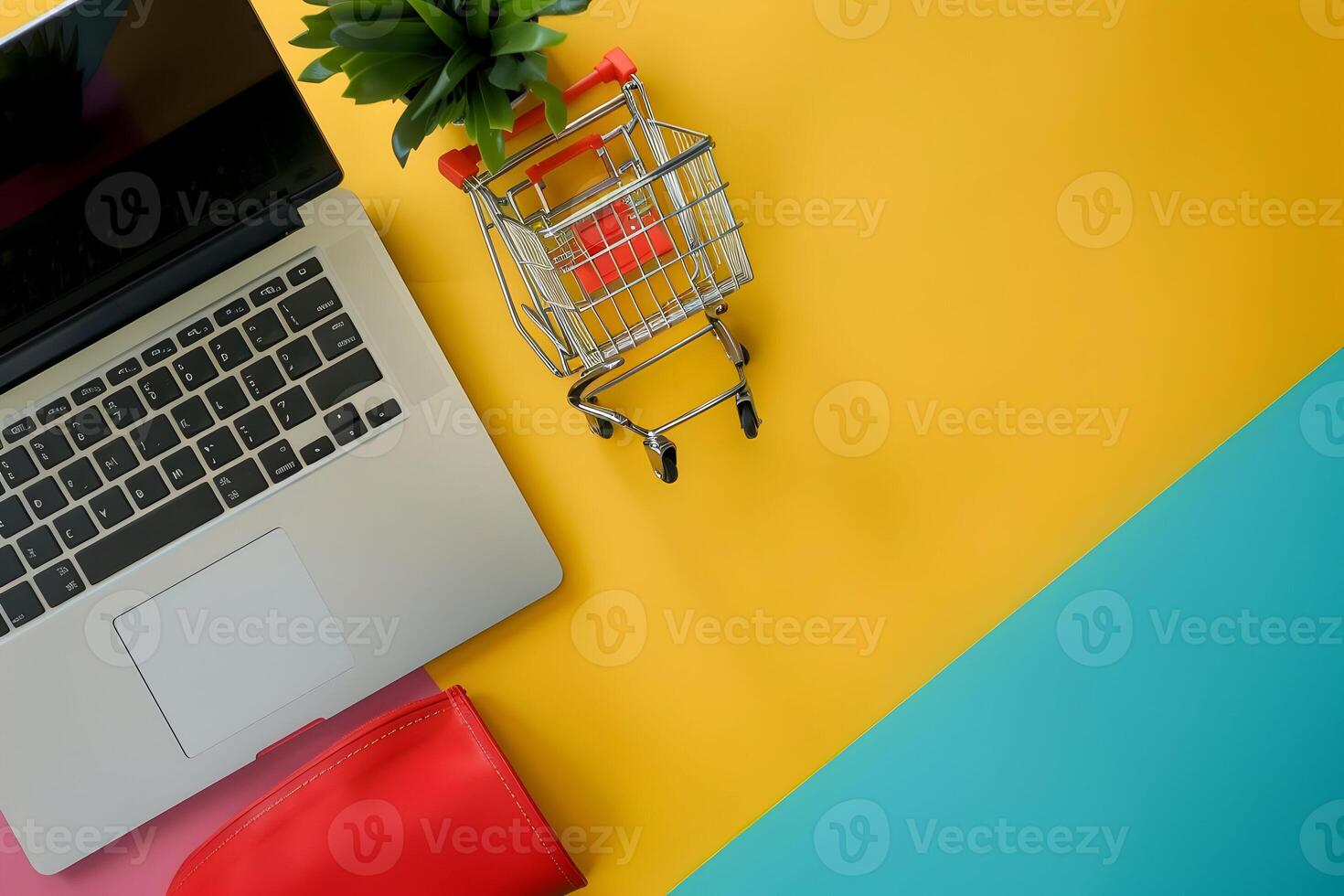 Shopping cart on colorful background with laptop and shopping bag photo