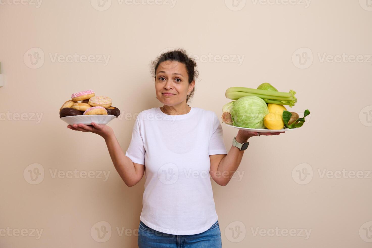 Woman Contemplating Between Sugary Doughnuts and Fresh Healthy Fruits and Vegetables photo
