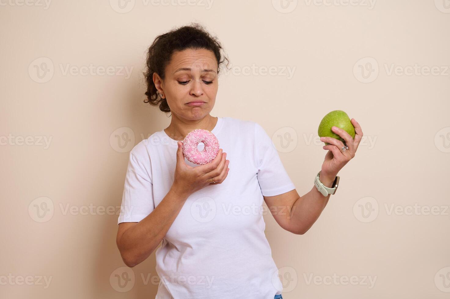 Choosing Between a Healthy Apple and a Doughnut with Sprinkles Depicting a Lifestyle Choice Moment photo