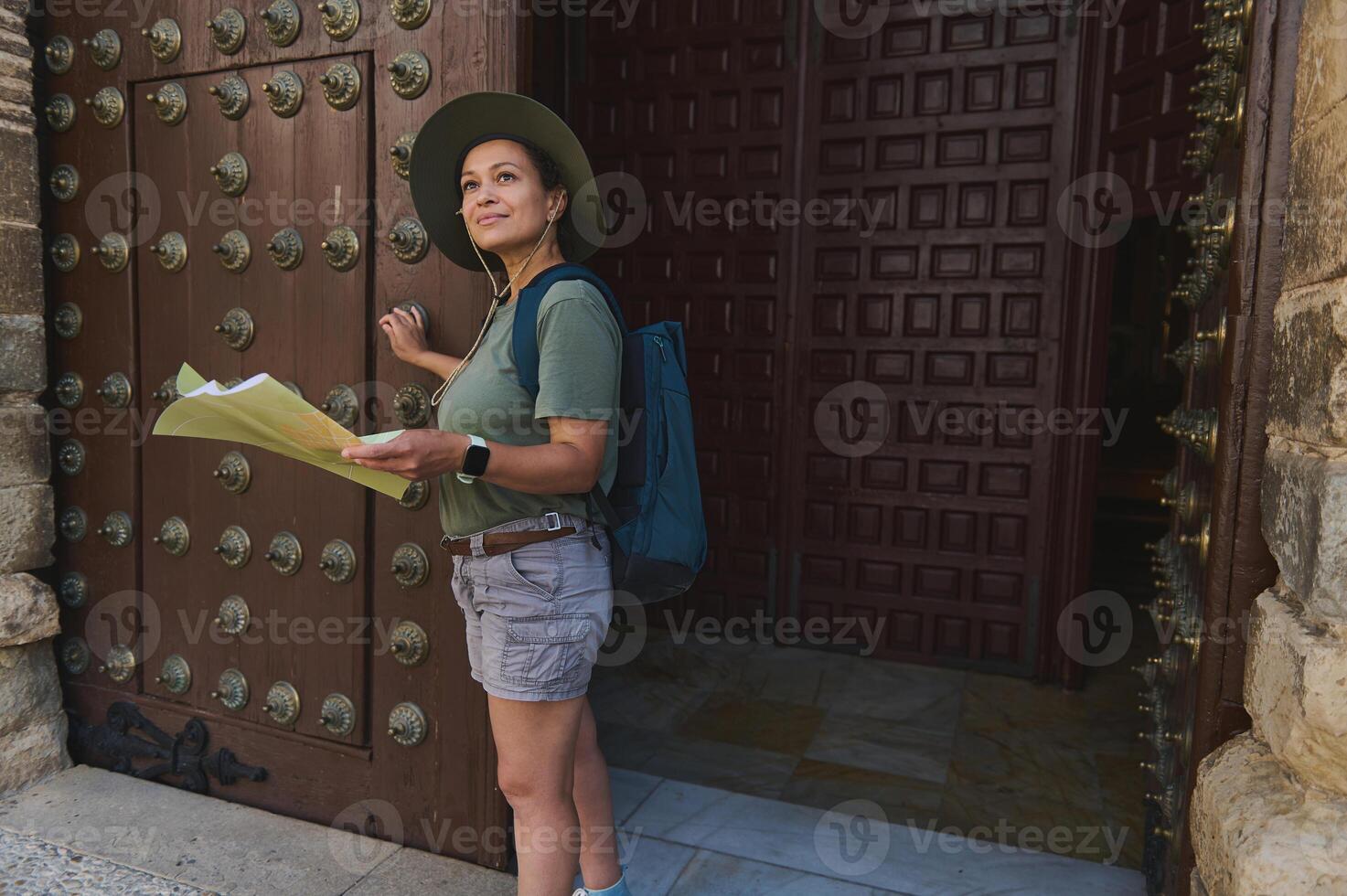 Traveler Exploring Medieval Heritage with Map Near Historic Doorway photo