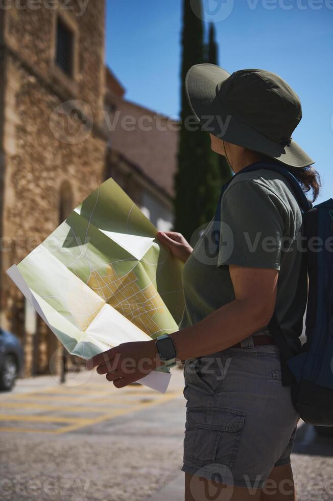 Traveler Exploring a Historic Village with a Map in Hand photo