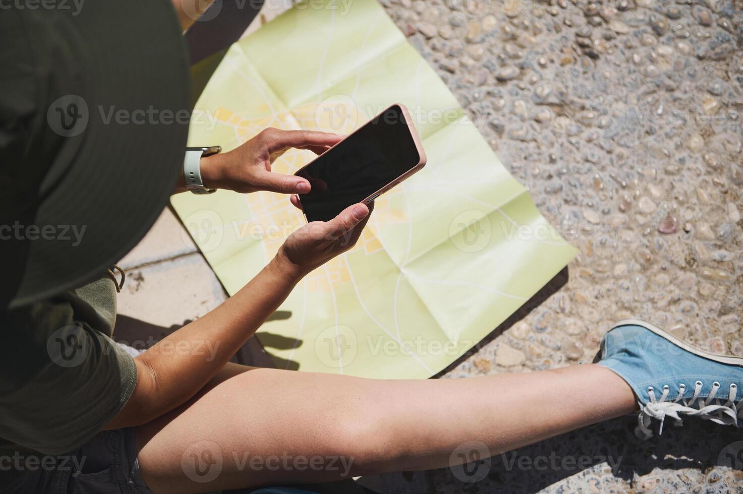 Traveler Viewing Smartphone Over Map of Medieval City Outdoors photo