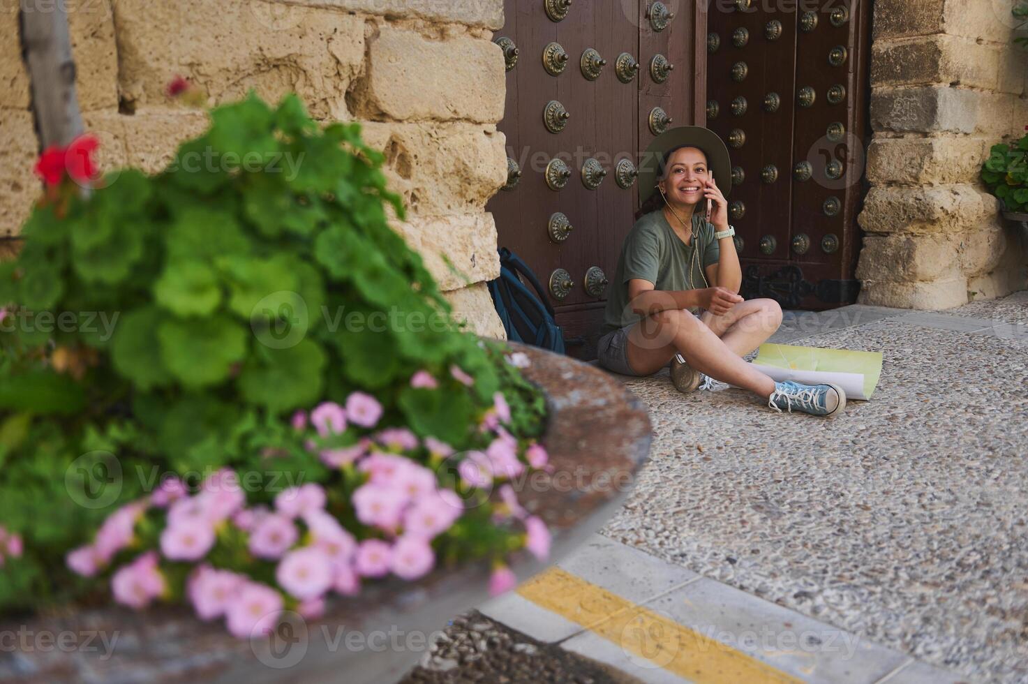 Young Female Traveler Exploring a Medieval Village with Map and Phone photo