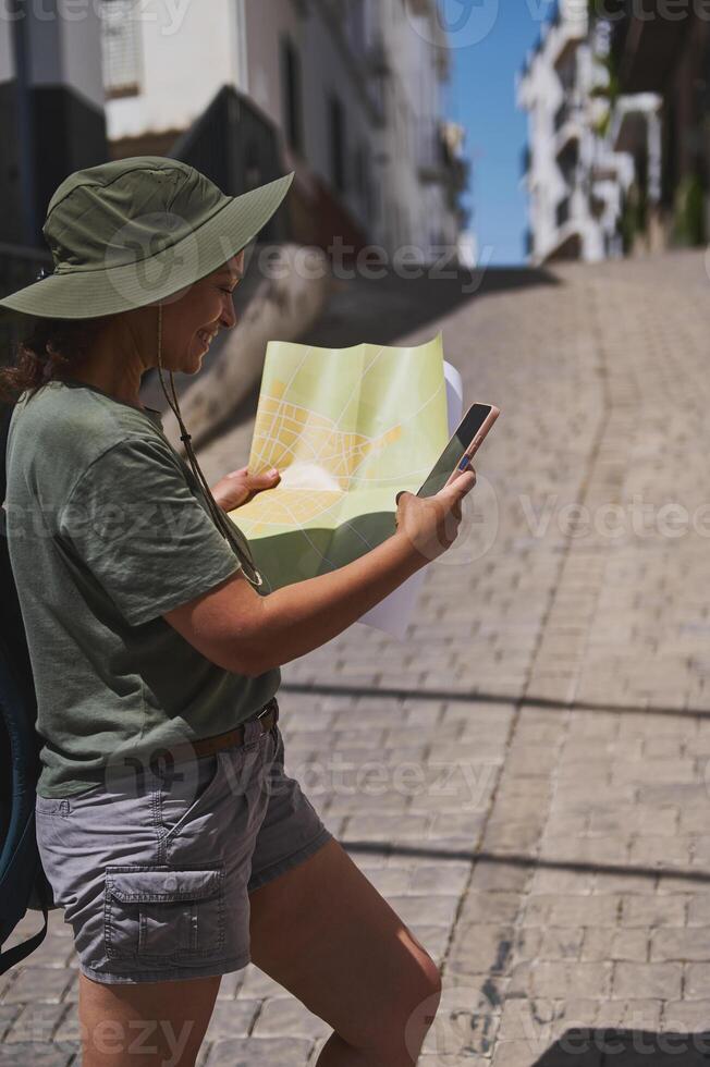 Traveler Exploring Spanish Village Holding Map Outdoors photo
