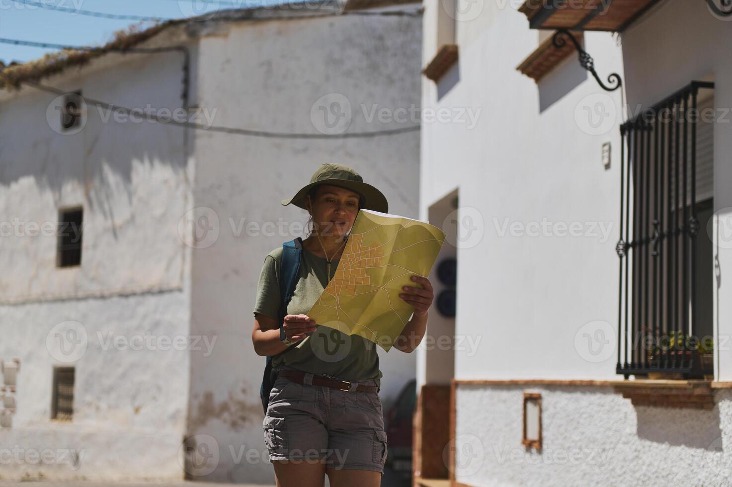 Tourist Exploring Charming Spanish Village with Map in Hand photo