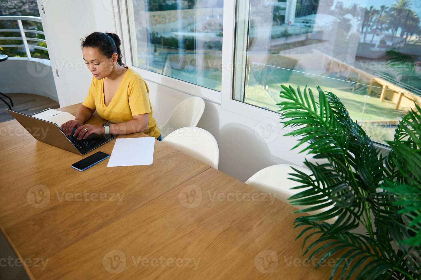 Focused Entrepreneur Working Remotely From a Modern Bright Home Office With Internet Access photo