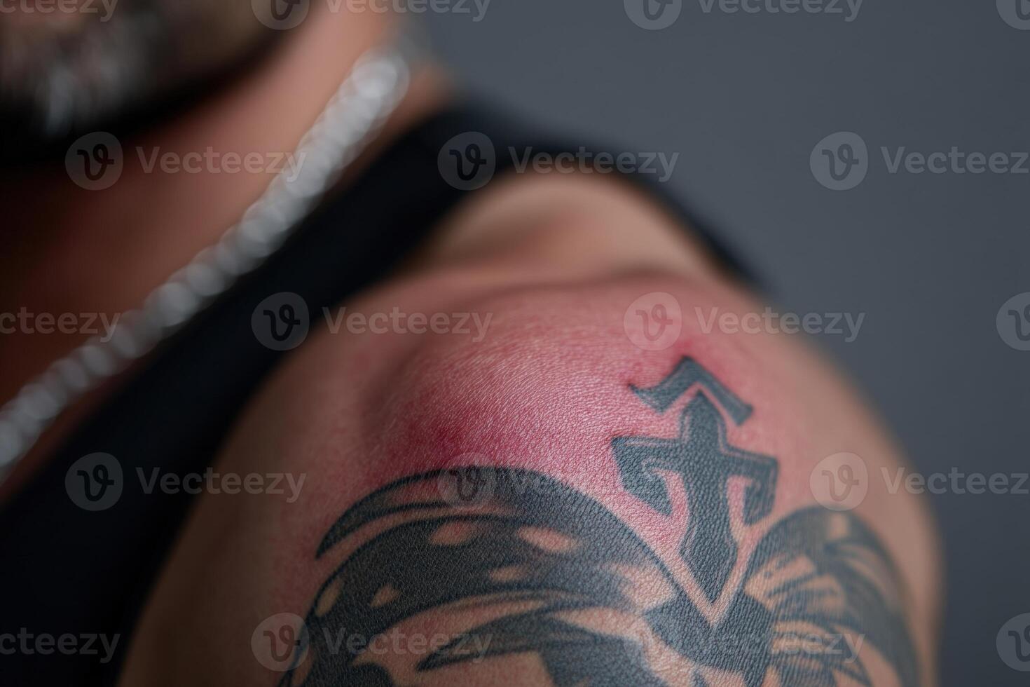 Detailed tattoo design on shoulder with slight irritation after recent application photo