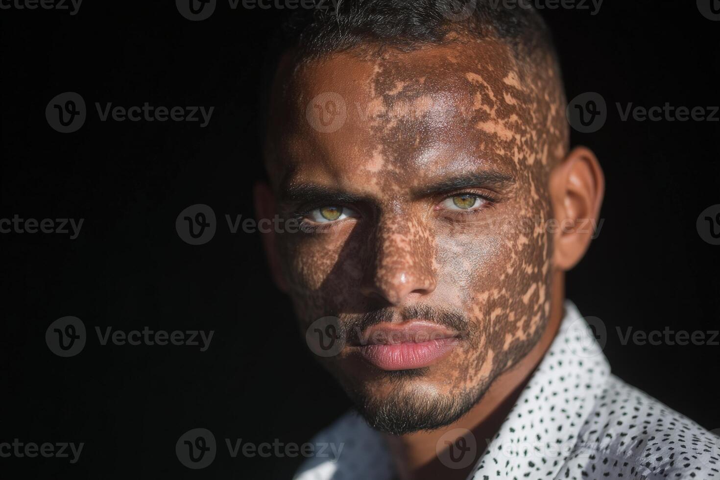 Portrait of a young man with striking eyes and unique facial patterns in natural light photo